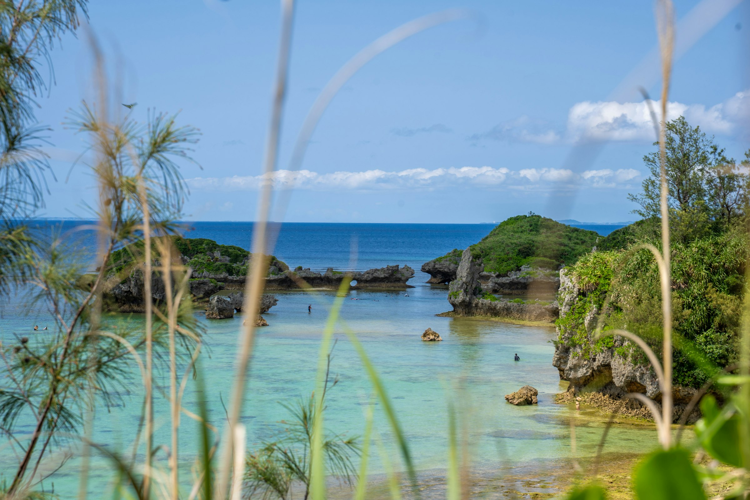 A turquoise lagoon and rocky coastline in Okinawa
